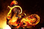 Lower right angle of Ghost Rider on his Hell Cycle, swinging a fiery chain whip with his flaming skull roaring, set against a fiery black background. Collector Edition (Prototype Shown) View 5
