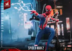 Full body shot of Peter Parker in Advanced Suit 2.0, kneeling on his right knee, shooting webs with his right hand and slinging webs with his left, set against a night city background. (Prototype Shown) View 3