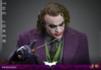 Upper body shot of The Joker (Collector Edition), holding a knife and slightly pointing with his right hand, head tilted down, and eyes looking up. (Prototype Shown) View 16