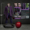 Full body shot of The Joker (Collector Edition) displaying the figure's scale in comparison to an apple, with smaller portraits highlighting the contents of the box. (Prototype Shown) View 2