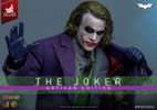 Half body shot of The Joker (Artisan Edition) opening his topcoat to reveal weapons, holding a pin and string with his right thumb. Collector Edition (Prototype Shown) View 1