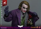 Half body shot of The Joker (Artisan Edition) opening his topcoat to reveal weapons, holding a pin and string with his right thumb. Collector Edition (Prototype Shown) View 15