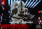 Half body shot of Imperial Commando™ in wide squat, right leg forward, holding blaster rifle by chest, highlighting detailed armor and weapon design. (Prototype Shown) View 16