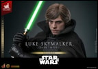 Close-up portrait of Luke Skywalker™ (Dark Empire) showcasing a serious expression, holding his green lightsaber on the right side of his face with both hands. (Prototype Shown) View 5