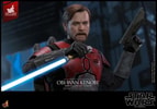 Half-body shot of Obi-Wan Kenobi™ holding a lightsaber in reverse grip with his right hand while raising a blaster pistol in his left hand. (Prototype Shown) View 14