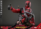 Half body shot of Deadpool Sixth Scale Action Figure by Hot Toys, right arm out with thumbs up, holding Babypool on chest. Collector Edition (Prototype Shown) View 7