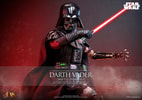 Half-body shot of Darth Vader™ (Battle Damaged) holding a lightsaber in his right hand across his body while raising his mechno left arm. Collector Edition (Prototype Shown) View 1