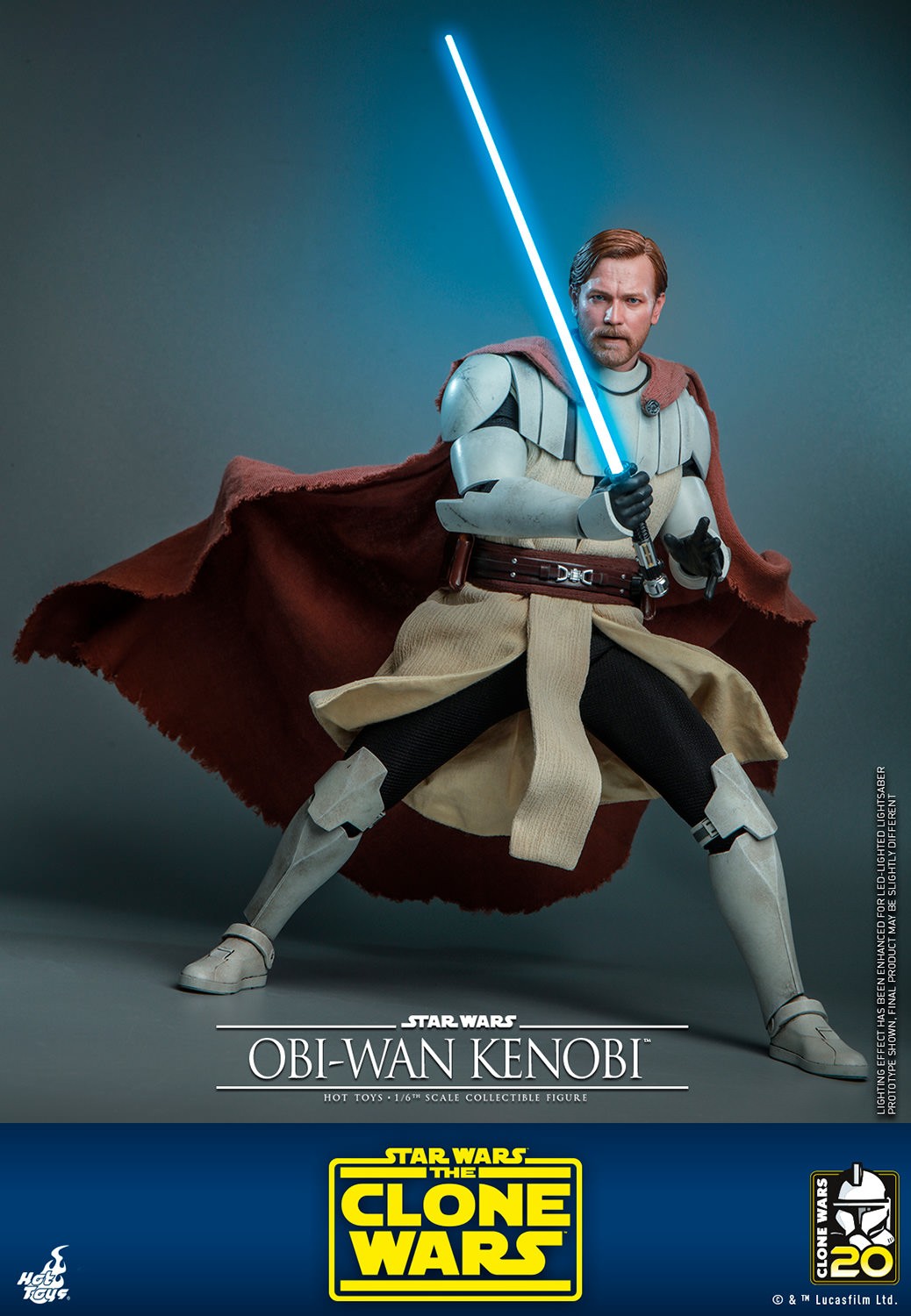 Full-body shot of Obi-Wan Kenobi in a wide stance, gripping his lightsaber in front of him, draped in his brown cape with a focused, serious expression. (Prototype Shown) View 9