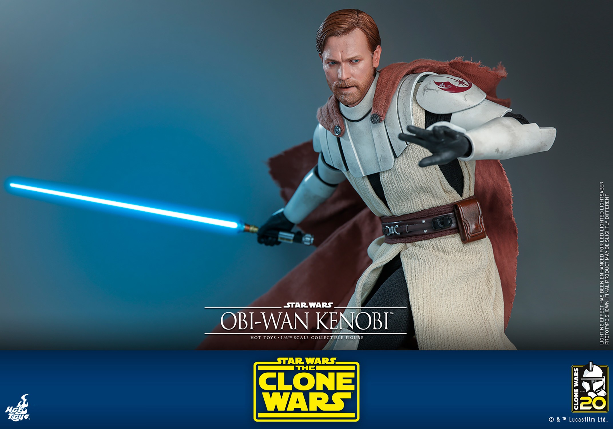 Left-angle view of Obi-Wan Kenobi with his brown cape, crouching with his left arm raised and bent, holding a lightsaber in his right hand near his torso, wearing a serious expression. (Prototype Shown) View 17