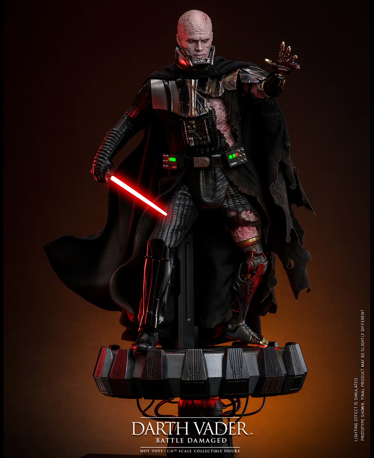 Wide shot of Darth Vader™ (Battle Damaged) unmasked, standing on a display base, holding a lightsaber in his right hand, and extending his mechno left arm. (Prototype Shown) View 4