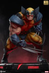 Front-angle view of Wolverine statue on a red-lit base, deeply crouched, highlighting his fierce berserker rage expression, muscles, and iconic claws. (Prototype Shown) View 3
