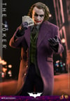 Knee-high shot of The Joker (Collector Edition) holding fanned out cards in his right hand, left palm up and open, with a lit-up city background, creating a dramatic and iconic atmosphere. (Prototype Shown) View 5