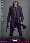 Full-body shot of The Joker (Collector Edition) standing with a machine gun in right hand, gloves on, head slightly down, on display base. (Prototype Shown) View 7