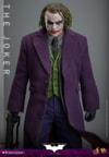 Knee-high shot of The Joker (Collector Edition) standing with a machine gun in right hand, gloves on and head slightly down. (Prototype Shown) View 12