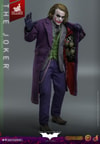 Full body shot of The Joker (Artisan Edition) opening his topcoat with left hand to reveal weapons, holding a pin and string with his right thumb, and right leg slightly forward. Collector Edition (Prototype Shown) View 3