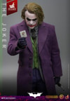 Half body shot of The Joker (Artisan Edition) wearing black gloves, holding a card in his right hand near his chest, and a knife in his left hand by his side. Collector Edition (Prototype Shown) View 4