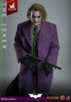 Knee-high shot of The Joker (Artisan Edition) looking forward, holding a machine gun with both hands, arms slightly bent upwards. Collector Edition (Prototype Shown) View 11