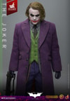 Knee-high shot of The Joker (Artisan Edition) with head slightly down, holding a machine gun in his right hand, arms positioned to the side. Collector Edition (Prototype Shown) View 13