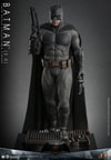 Full-body shot of Batman (2.0) on a display base, showcasing his full suit with precise armor detailing, holding a rifle in his right hand and a batarang in his left. Collector Edition (Prototype Shown) View 6