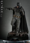 Left angle view of Batman (2.0) on display base, with his right knee bent, pointing a batarang with his right hand and holding a pistol in his left. Collector Edition (Prototype Shown) View 7