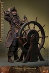 Full body shot of Jack Sparrow (Collector Edition) showing the right side, standing behind a ship's steering wheel, grinning, clutching his hat, and holding a compass in his left hand. Collector Edition (Prototype Shown) View 6