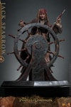 Full body shot of Jack Sparrow (Collector Edition) standing behind a ship's steering wheel, gripping the wheel with his right hand, holding up a gun with his left hand, and wearing his iconic red bandana. Collector Edition (Prototype Shown) View 7