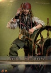 Half-body shot of Jack Sparrow (Deluxe Version) wearing a red bandana, looking through a tube telescope with his right hand, left arm on the ship's wheel, set against a mossy green background. (Prototype Shown) View 1