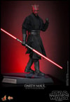 Full body shot of Darth Maul (Collector Edition) standing on display base, holding a dual-bladed lightsaber in his right hand, with his left arm curled up and upper body turned toward the front. Collector Edition (Prototype Shown) View 6