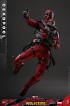 Air action shot of Deadpool Sixth Scale Action Figure by Hot Toys, slightly jumping with legs bent and spread, right arm extended with thumb out, Babypool strapped to chest. (Prototype Shown) View 8