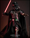 Full-body shot of Darth Vader™ (Battle Damaged) holding a lightsaber in his right hand, with his left hand extended forward in a commanding gesture. Collector Edition (Prototype Shown) View 5
