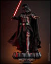 Full-body shot of Darth Vader™ (Battle Damaged) standing on a display base, holding a lightsaber in his right hand, with his left hand extended forward in a commanding gesture. (Prototype Shown) View 1