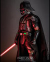 Left side view of Darth Vader™ (Battle Damaged) in full suit, holding a lightsaber in his right hand with his mechno left arm at his side. (Prototype Shown) View 5