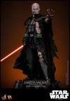 Left angle shot of Darth Vader™ (Battle Damaged) unmasked, displayed on a base, holding a lightsaber in his right hand, and extending his mechno left arm. (Prototype Shown) View 17