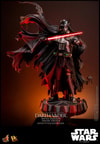 Full-body shot of Darth Vader™ (Battle Damaged) on a display base, featuring his battle-damaged helmet, silhouette cape, and holding a lightsaber in his right hand. (Prototype Shown) View 5