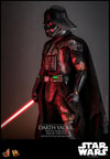 Left side view of Darth Vader™ (Battle Damaged) in full suit, holding a lightsaber in his right hand with his mechno left arm at his side. (Prototype Shown) View 16
