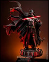 Full-body shot of Darth Vader™ (Battle Damaged) on a display base, featuring his battle-damaged helmet, silhouette cape, and holding a lightsaber in his right hand. (Prototype Shown) View 5