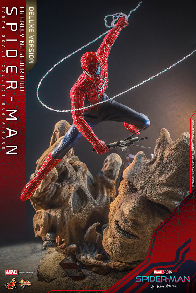 Action shot of Spider-Man leaping over a themed diorama figure stand showcasing Sandman amidst crumbling structures, dynamically holding the cure in his right hand and webbing in his left. Exclusive Edition - Prototype Shown View 3