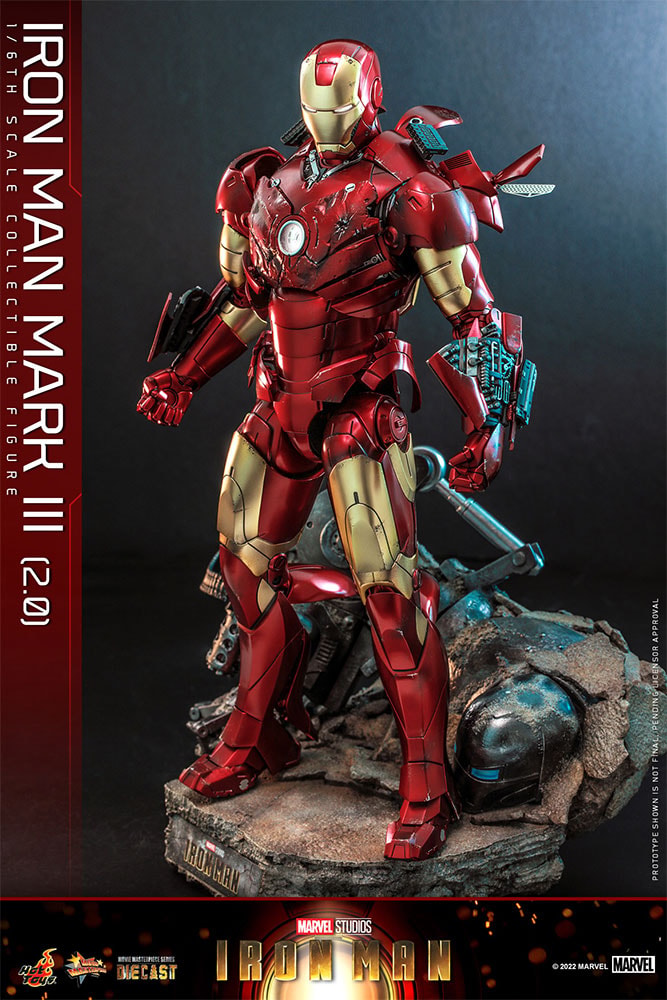Left-angle view of Iron Man Mark III (2.0) standing on a damaged Iron Monger diorama base, suit pieces flared out, and fists clenched. Collector Edition - Prototype Shown View 6
