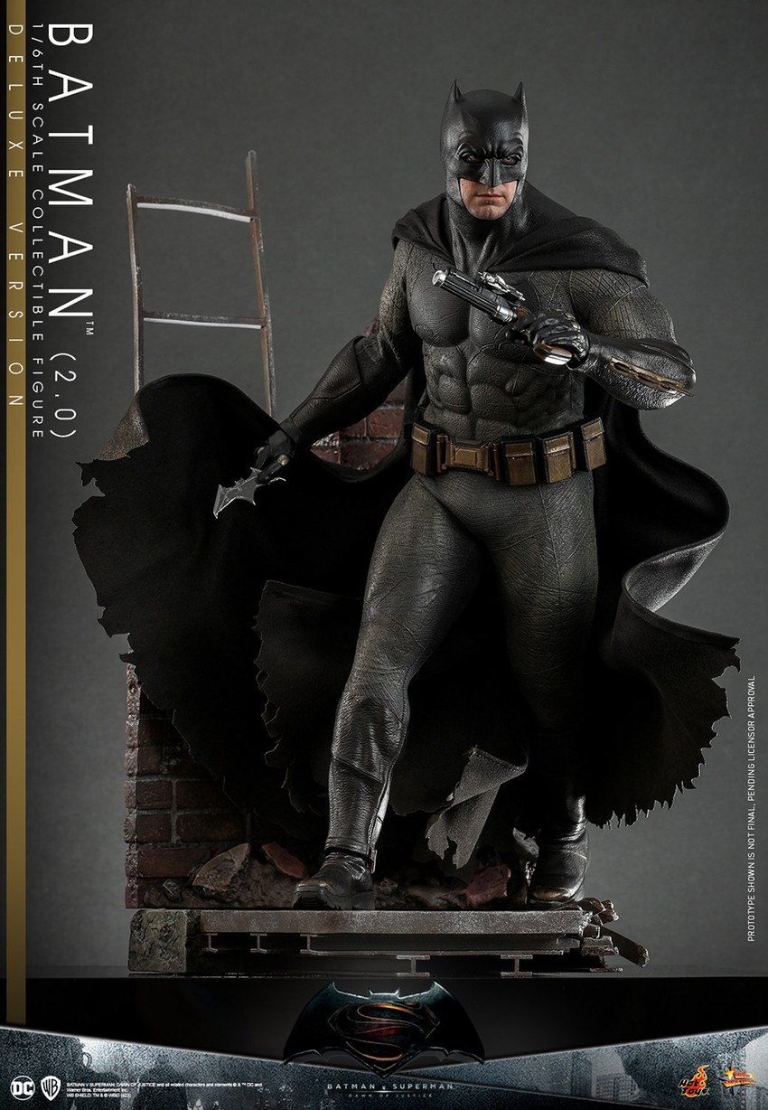 Full action shot of Batman (2.0) in alleyway diorama, leading with his right leg, holding a batarang with his right hand and a pistol with his left.- Prototype Shown View 6